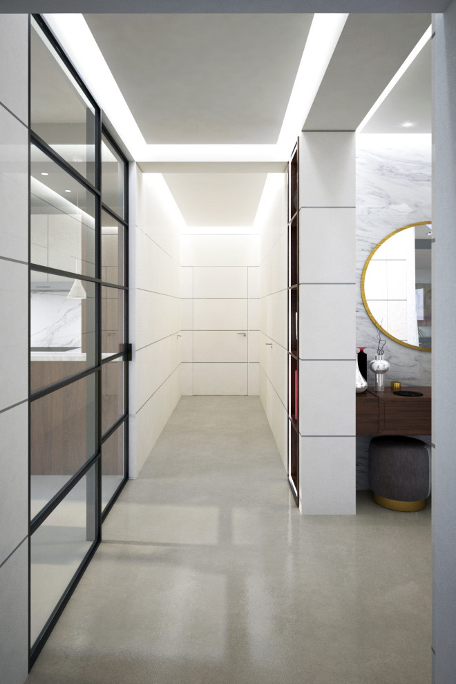 This is an example of a mid-sized contemporary foyer in Rome with white walls, concrete floors, beige floor, recessed and decorative wall panelling.