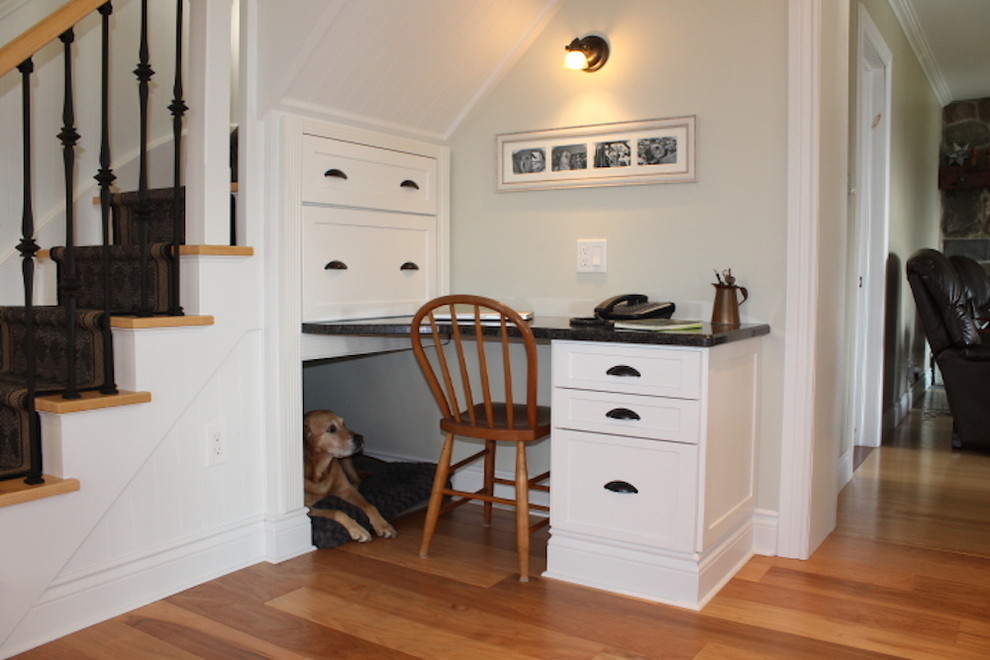 Study room - mid-sized traditional built-in desk medium tone wood floor and brown floor study room idea in Toronto with beige walls