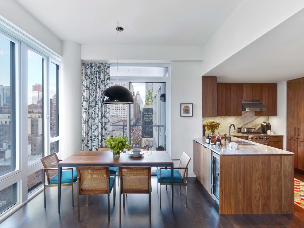 Design ideas for a mid-sized eclectic kitchen/dining combo in New York with white walls, medium hardwood floors and brown floor.
