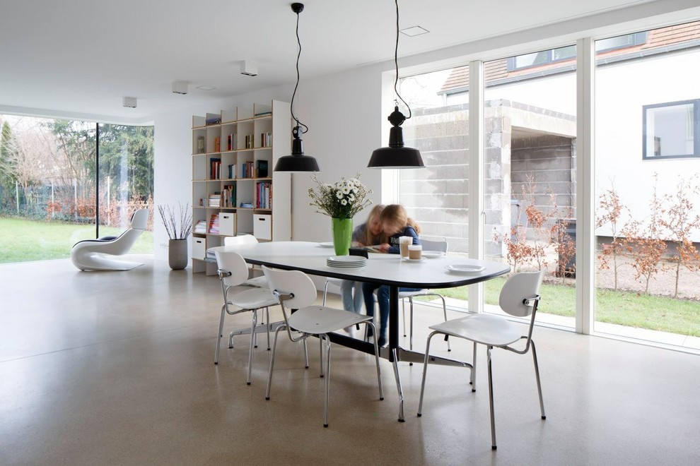 Photo of an expansive contemporary open plan dining in Cologne with white walls.
