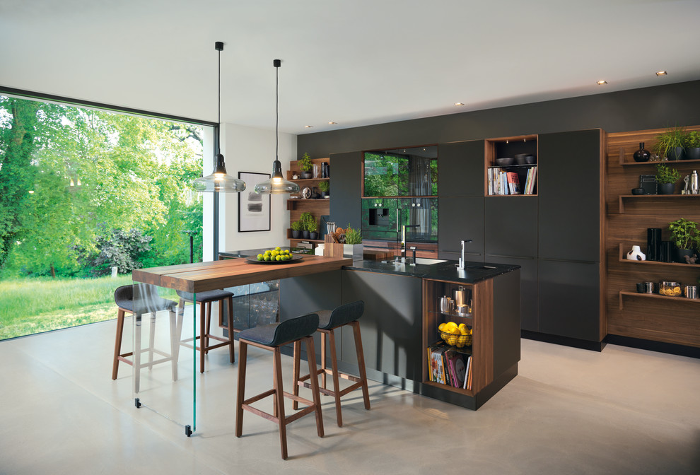 Design ideas for an expansive contemporary open plan kitchen in Hanover with a drop-in sink, flat-panel cabinets, black cabinets, laminate benchtops, white splashback, stone slab splashback, stainless steel appliances, linoleum floors, with island and beige floor.
