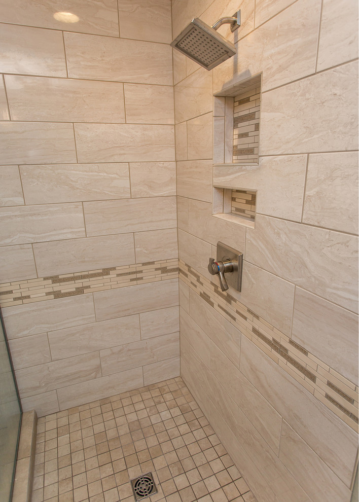 This is an example of a mid-sized traditional master bathroom in Other with raised-panel cabinets, medium wood cabinets, a freestanding tub, a corner shower, a two-piece toilet, beige tile, ceramic tile, beige walls, ceramic floors, an undermount sink, engineered quartz benchtops, beige floor, a hinged shower door and beige benchtops.