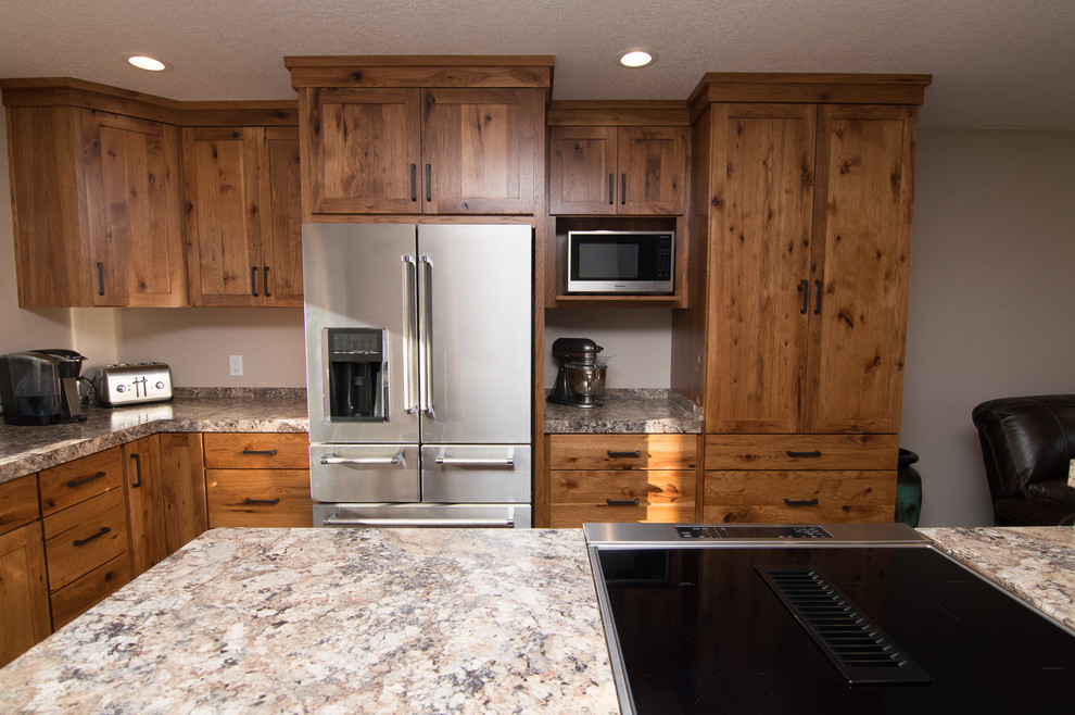 Inspiration for a mid-sized rustic l-shaped medium tone wood floor and brown floor eat-in kitchen remodel in Denver with an undermount sink, shaker cabinets, medium tone wood cabinets, quartz countertops, black appliances, an island and multicolored countertops