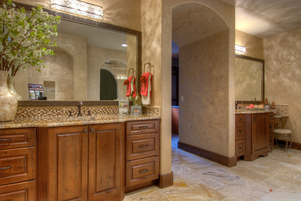 Large traditional master bathroom in Denver with raised-panel cabinets, medium wood cabinets and beige tile.
