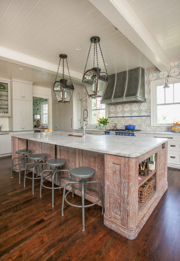 Photo of a large eclectic kitchen in Charleston with a farmhouse sink, shaker cabinets, white cabinets, white splashback, ceramic splashback, stainless steel appliances, dark hardwood floors and with island.