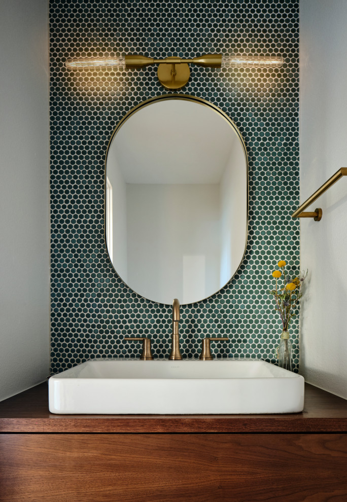 Small mid-century modern blue tile and mosaic tile powder room photo in Austin with flat-panel cabinets, dark wood cabinets, white walls, a vessel sink, wood countertops, brown countertops and a floating vanity
