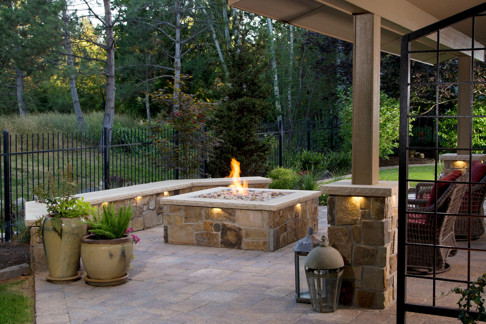 Inspiration for a mid-sized traditional backyard patio in Boise with a fire feature, concrete pavers and a roof extension.