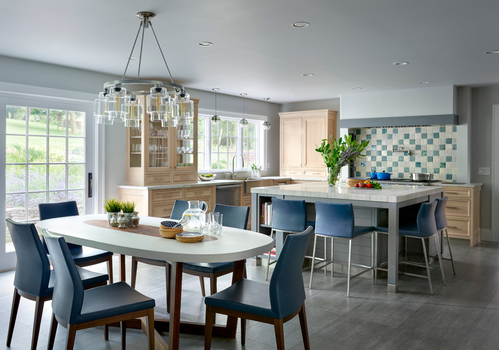 Inspiration for a large transitional u-shaped porcelain tile eat-in kitchen remodel in New York with a farmhouse sink, recessed-panel cabinets, light wood cabinets, quartzite countertops, gray backsplash, ceramic backsplash, paneled appliances and an island