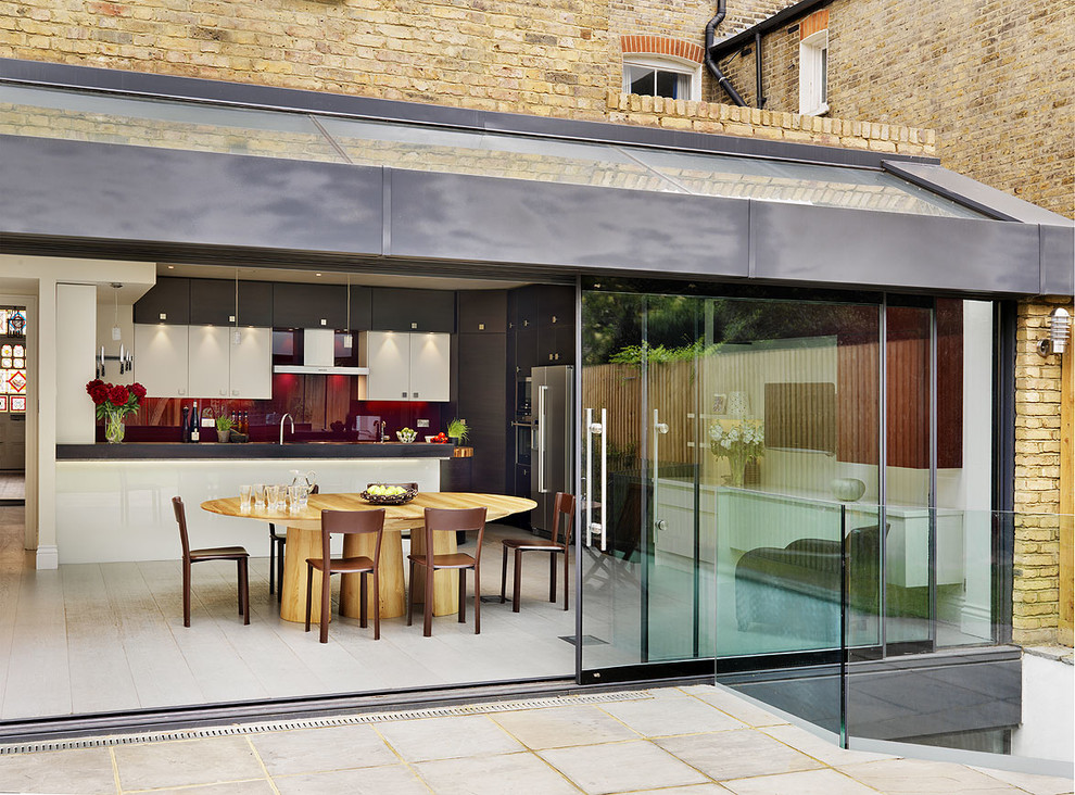 This is an example of a contemporary kitchen/dining combo in London.