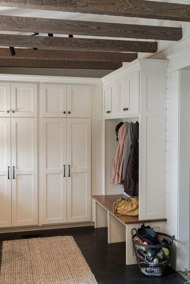 Photo of a small country mudroom in Other with white walls, ceramic floors, a single front door, a medium wood front door, grey floor, exposed beam and planked wall panelling.