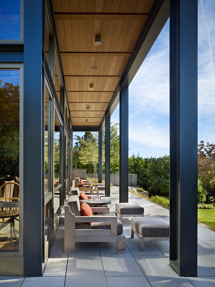 Inspiration for a modern verandah in Seattle with a roof extension.