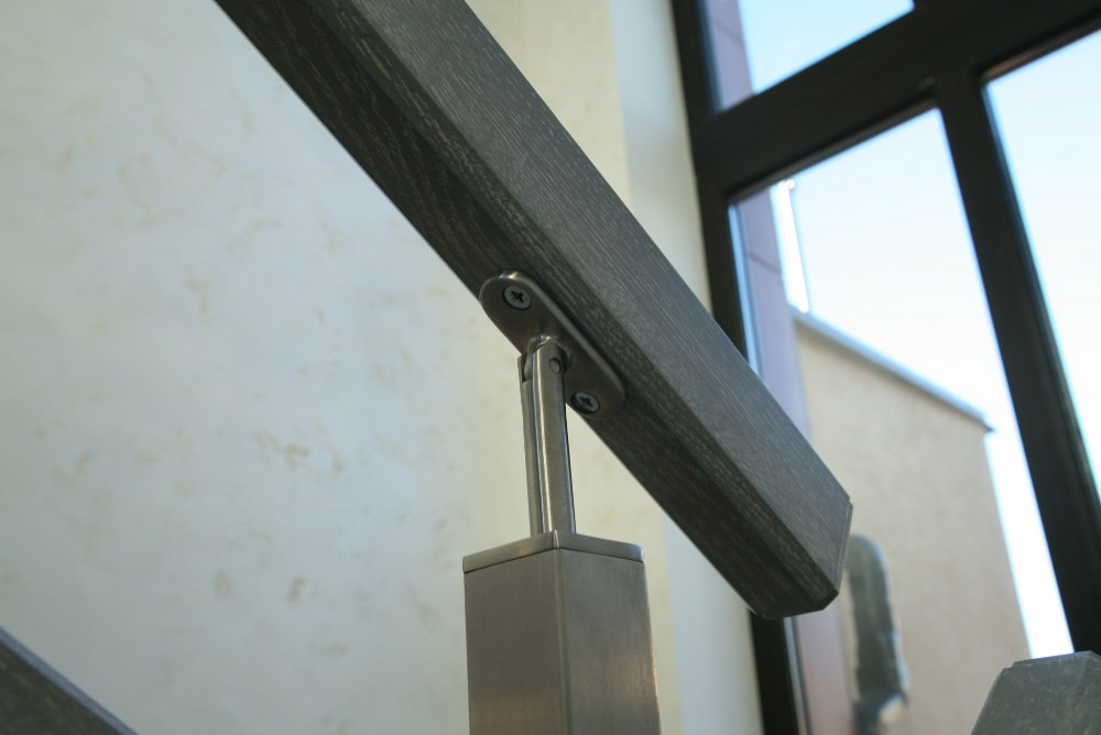 Modern metal stair covered by patina oak