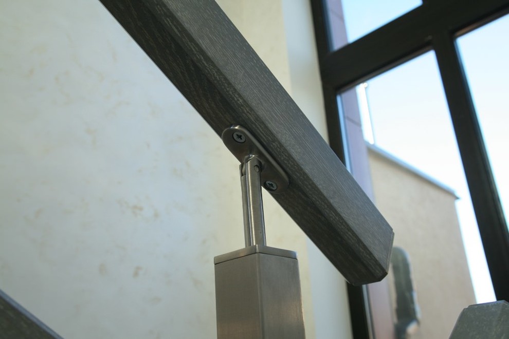 Modern metal stair covered by patina oak