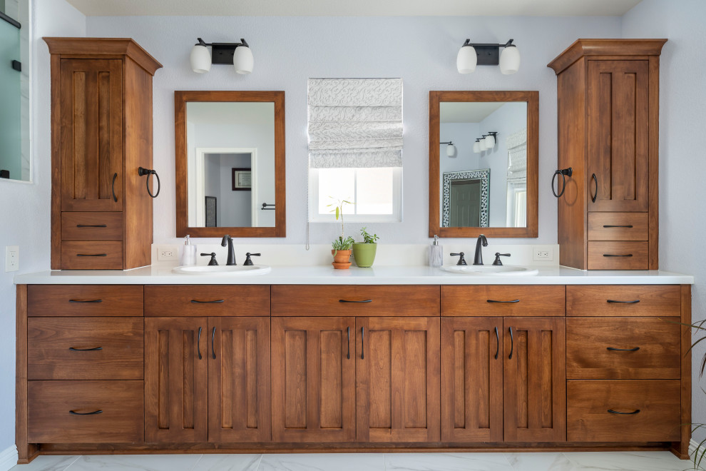 Inspiration for a large traditional ensuite bathroom in Los Angeles with raised-panel cabinets, brown cabinets, a corner shower, a two-piece toilet, grey walls, a submerged sink, engineered stone worktops, multi-coloured floors, a hinged door, white worktops, an enclosed toilet, double sinks, a built in vanity unit and ceramic flooring.