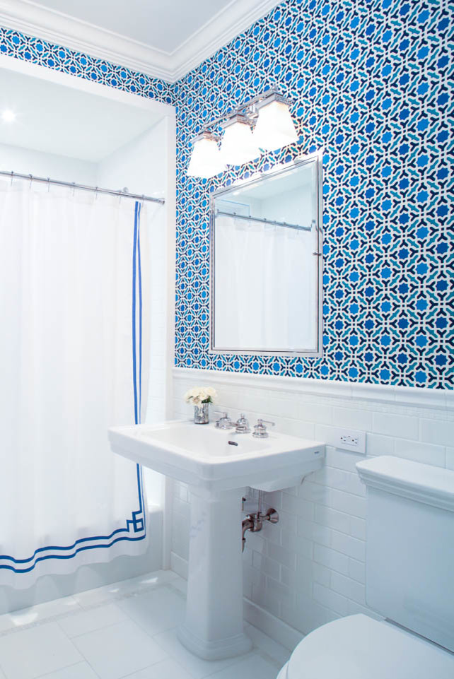 Mid-sized contemporary 3/4 bathroom in New York with an alcove tub, a shower/bathtub combo, a two-piece toilet, white tile, subway tile, multi-coloured walls, porcelain floors and a pedestal sink.