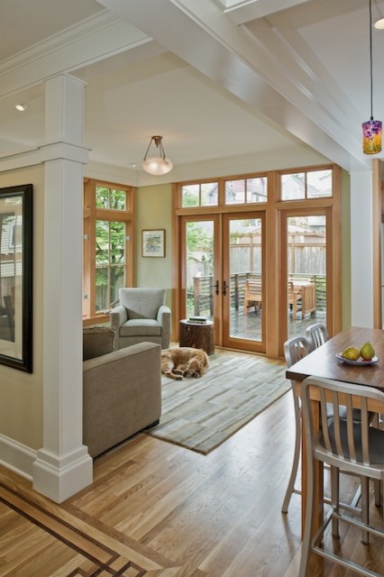 Design ideas for a mid-sized arts and crafts open plan dining in Seattle with beige walls and light hardwood floors.