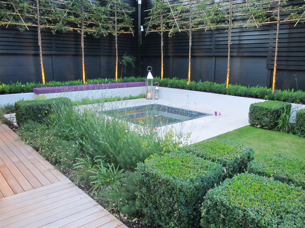 This is an example of a mid-sized contemporary courtyard garden in London with decking.