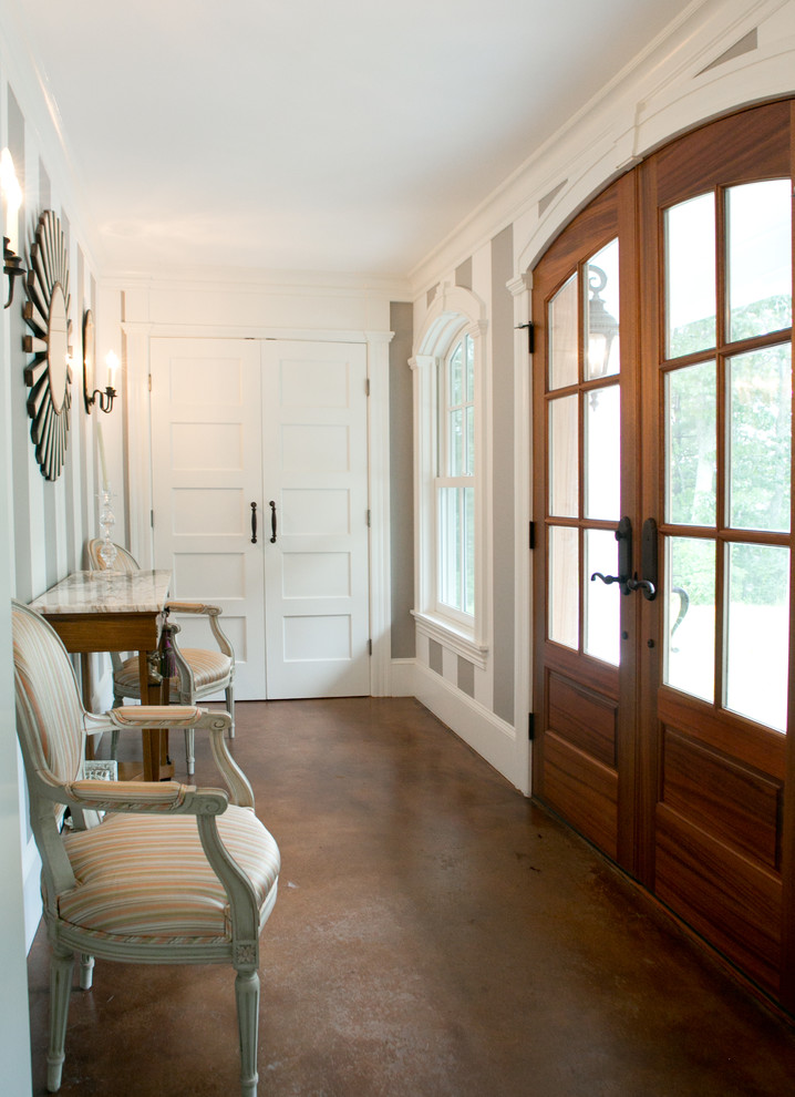 Photo of a traditional foyer in Portland Maine with white walls and a double front door.