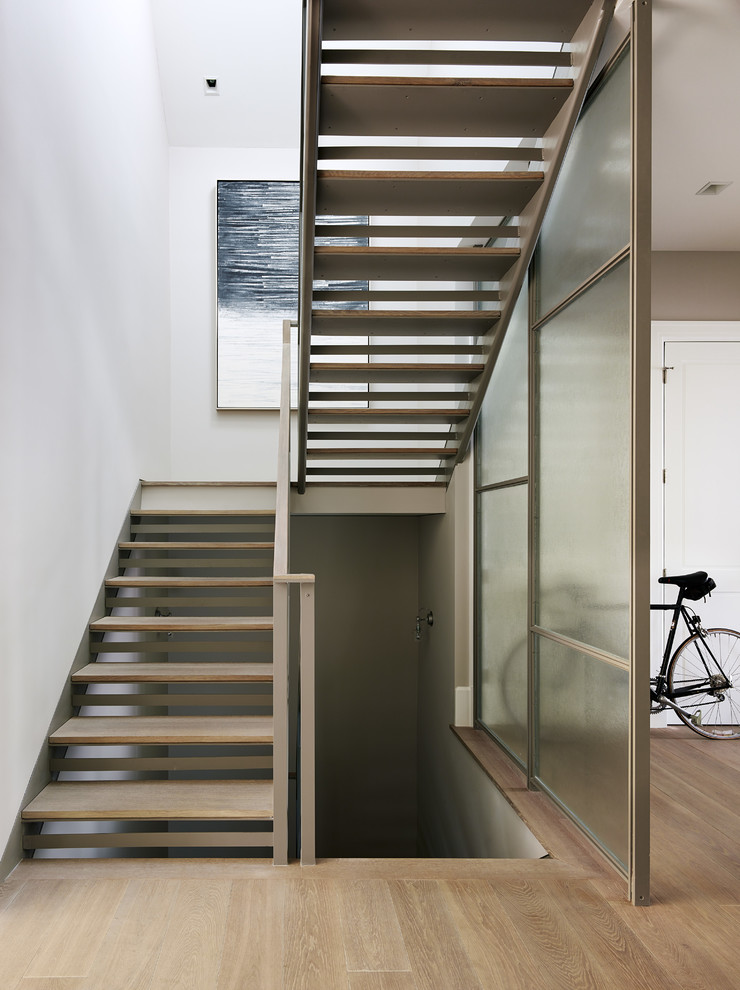 Photo of a transitional wood l-shaped staircase in San Francisco with open risers.