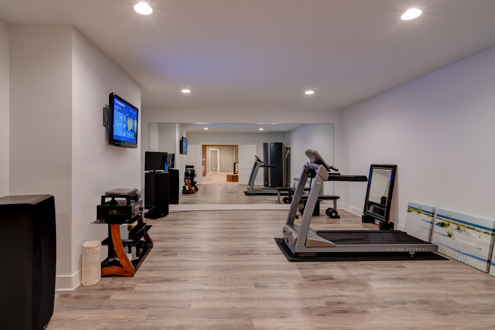 This is an example of an arts and crafts multipurpose gym in Indianapolis with grey walls, vinyl floors and brown floor.