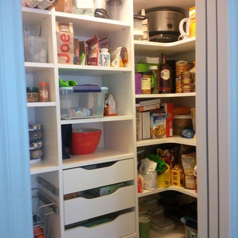 Example of a small single-wall medium tone wood floor kitchen pantry design with flat-panel cabinets, white cabinets and no island