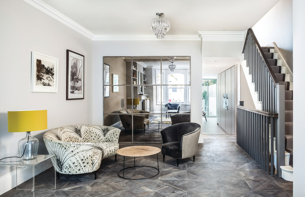 Large contemporary foyer in London with grey walls, grey floor and dark hardwood floors.