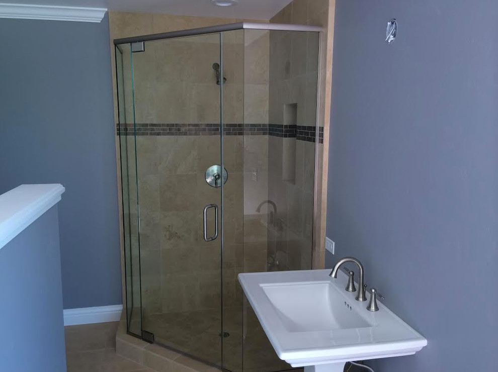 This is an example of a small modern bathroom in Sacramento with a pedestal sink, a corner shower, beige tile, beige walls, travertine floors, travertine, beige floor and a hinged shower door.