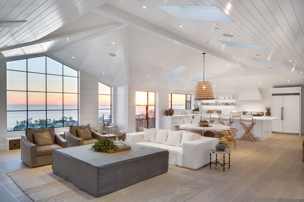 Design ideas for a large beach style open concept living room in Orange County with white walls, light hardwood floors, vaulted, wood and planked wall panelling.