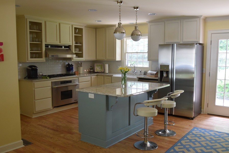 This is an example of a midcentury kitchen in Little Rock with recessed-panel cabinets and white cabinets.