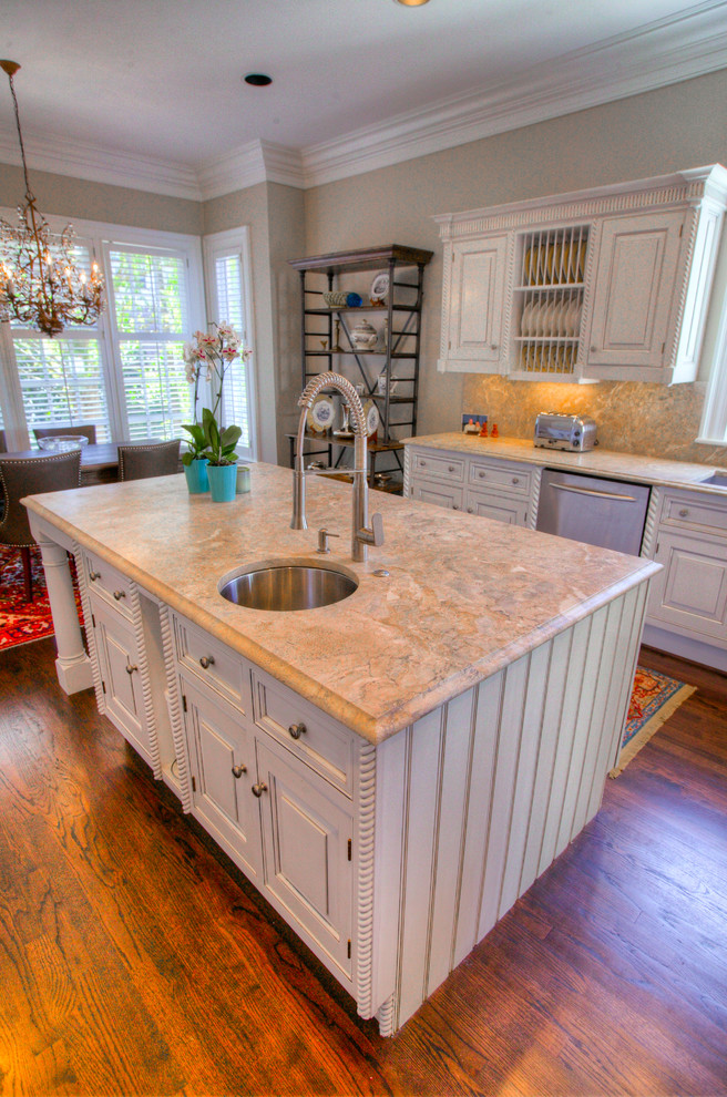Mid-sized transitional l-shaped medium tone wood floor eat-in kitchen photo in Charlotte with an undermount sink, raised-panel cabinets, white cabinets, marble countertops, multicolored backsplash, stone slab backsplash, stainless steel appliances and an island