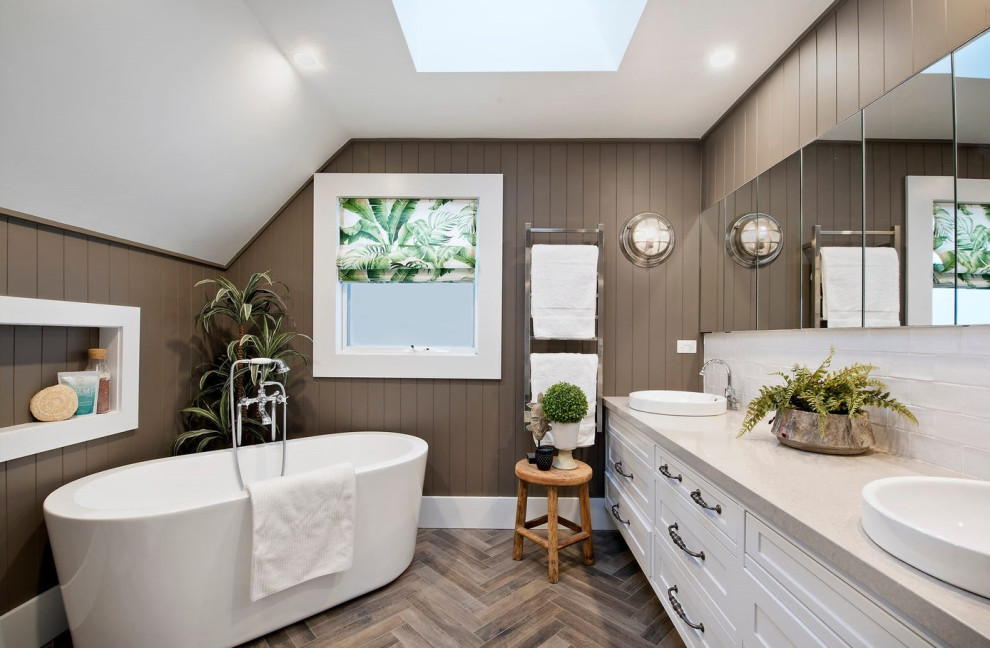 Inspiration for a large master bathroom in Sydney with shaker cabinets, white cabinets, a freestanding tub, white tile, subway tile, brown walls, porcelain floors, engineered quartz benchtops, brown floor, beige benchtops, a double vanity, a floating vanity, vaulted and decorative wall panelling.