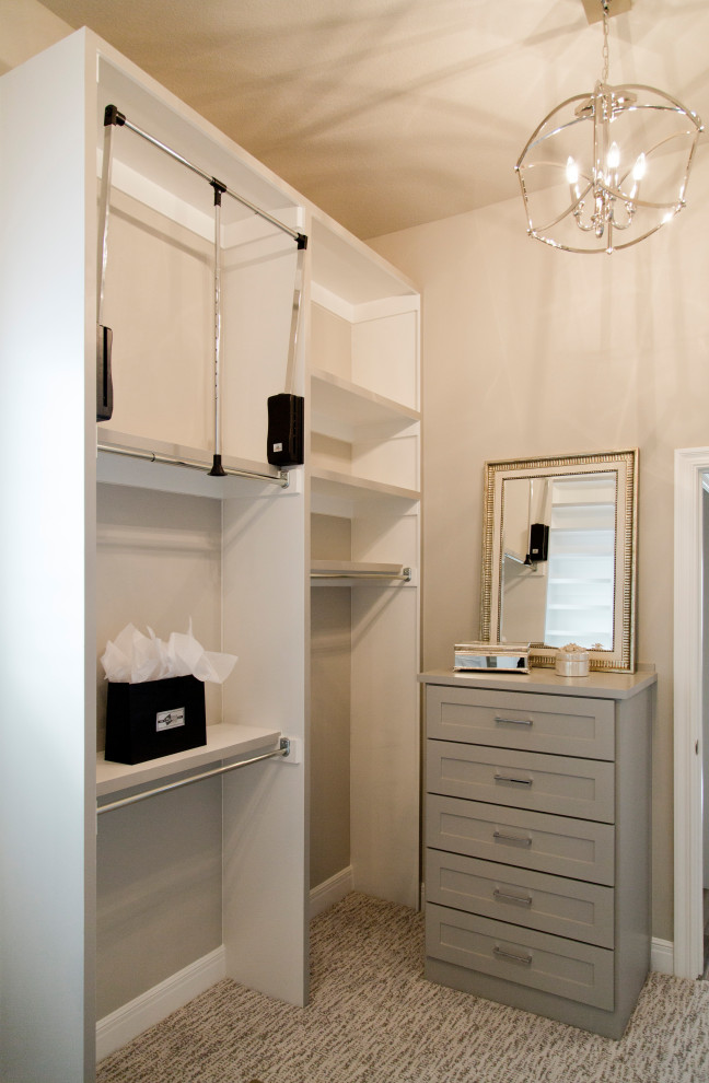Photo of a large beach style gender-neutral walk-in wardrobe in Kansas City with shaker cabinets, carpet and beige floor.