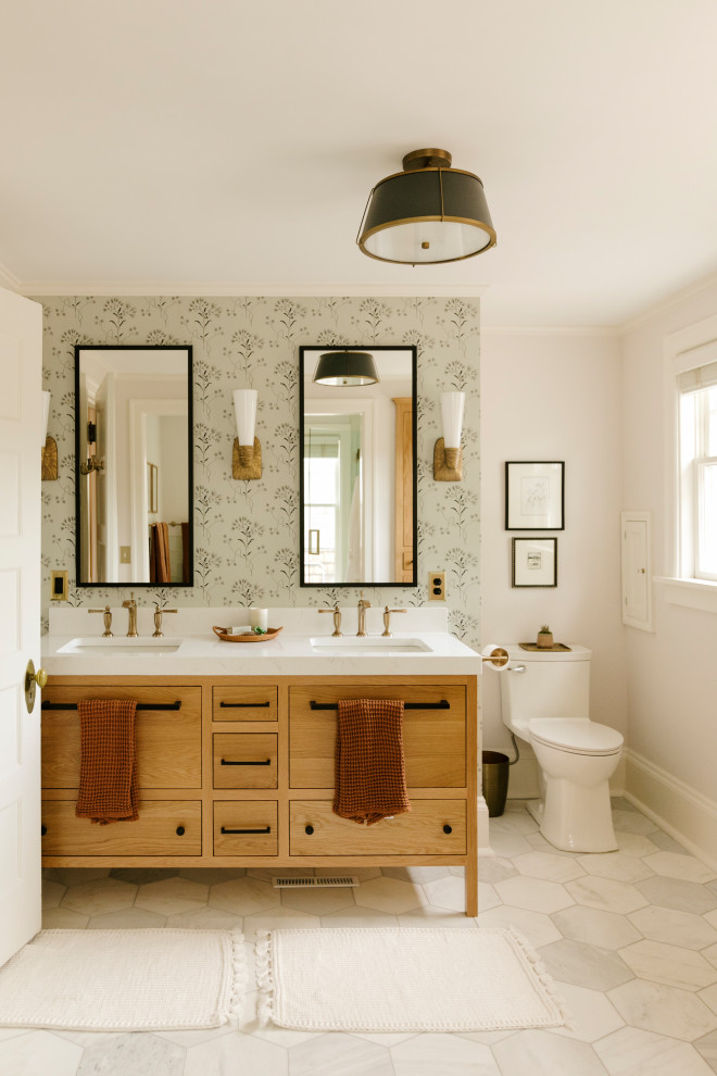 Mid-sized transitional master double-sink and wallpaper bathroom photo in Minneapolis with medium tone wood cabinets, a two-piece toilet, a hinged shower door, white countertops, a niche and a freestanding vanity