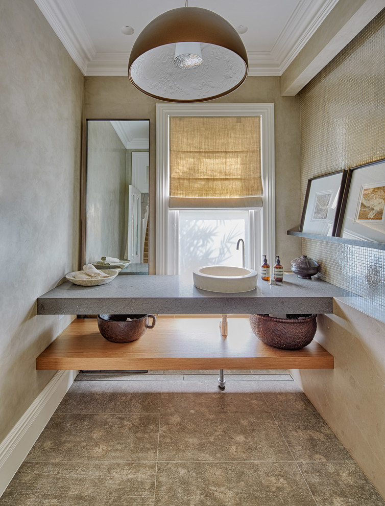 This is an example of a contemporary powder room in Sydney with a vessel sink, beige tile, mosaic tile and beige walls.