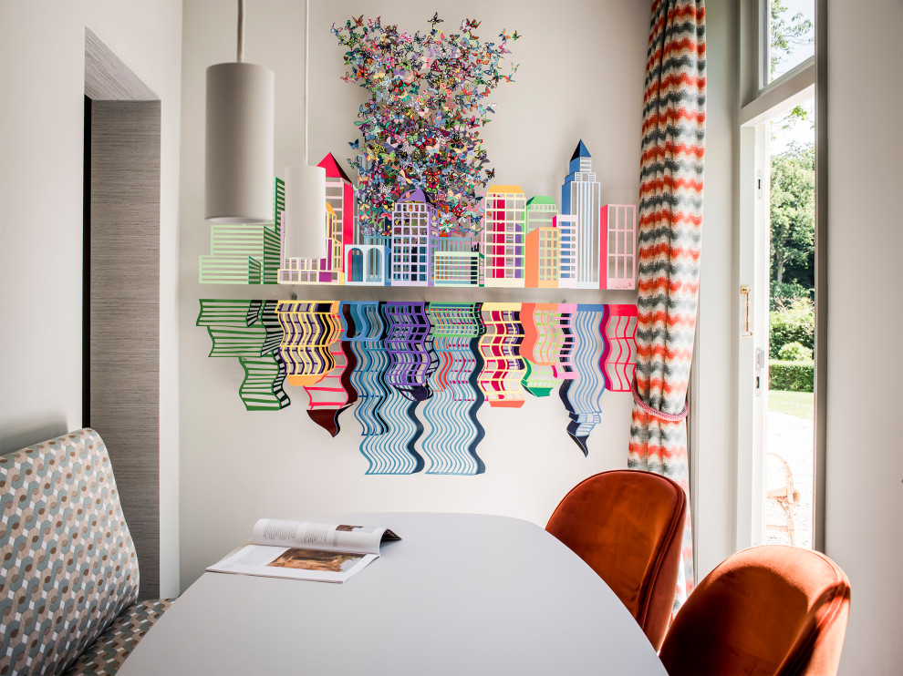 This is an example of an eclectic dining room in Amsterdam.