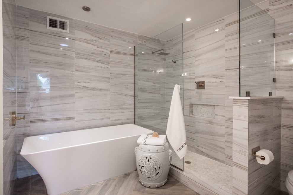 Large midcentury master bathroom in Phoenix with shaker cabinets, grey cabinets, a freestanding tub, an open shower, a one-piece toilet, multi-coloured tile, porcelain tile, white walls, porcelain floors, an undermount sink and engineered quartz benchtops.