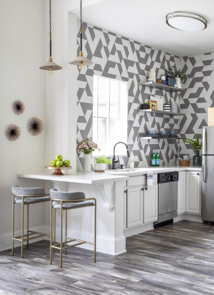 Example of a transitional l-shaped gray floor kitchen design in Houston with an undermount sink, raised-panel cabinets, white cabinets, quartz countertops, multicolored backsplash, stainless steel appliances and white countertops