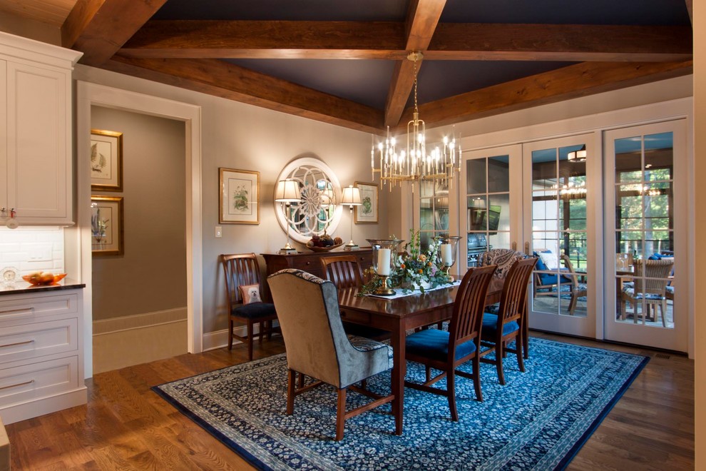 Example of a mid-sized transitional medium tone wood floor and brown floor kitchen/dining room combo design with blue walls