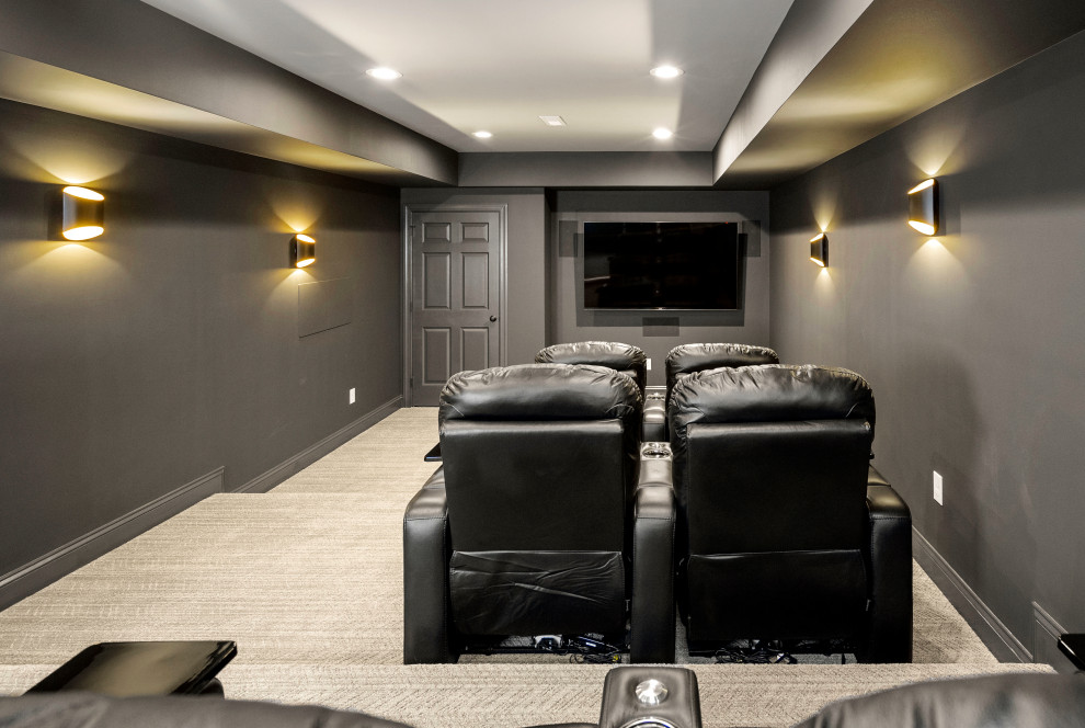 На фото: большой изолированный домашний кинотеатр в стиле кантри с черными стенами, ковровым покрытием, проектором и серым полом