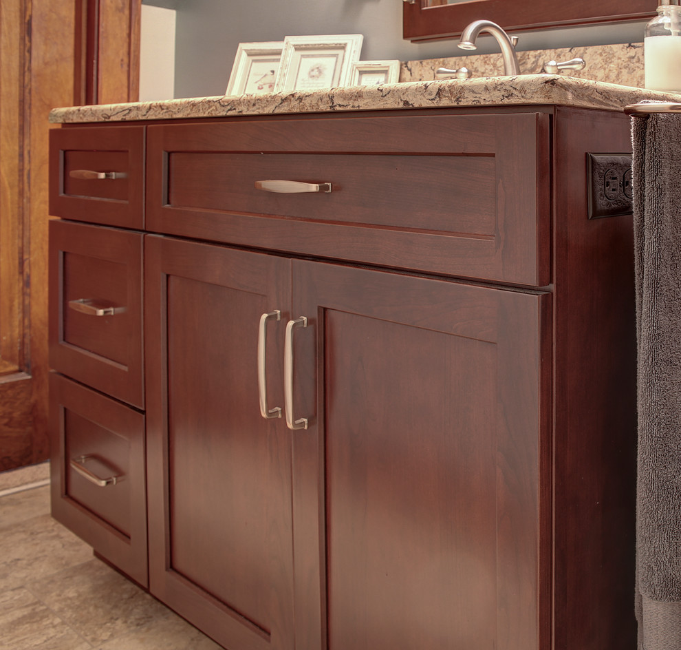 Example of a mid-sized transitional ceramic tile and beige tile ceramic tile and beige floor doorless shower design with recessed-panel cabinets, dark wood cabinets, a two-piece toilet, green walls, an undermount sink, quartzite countertops, a hinged shower door and multicolored countertops