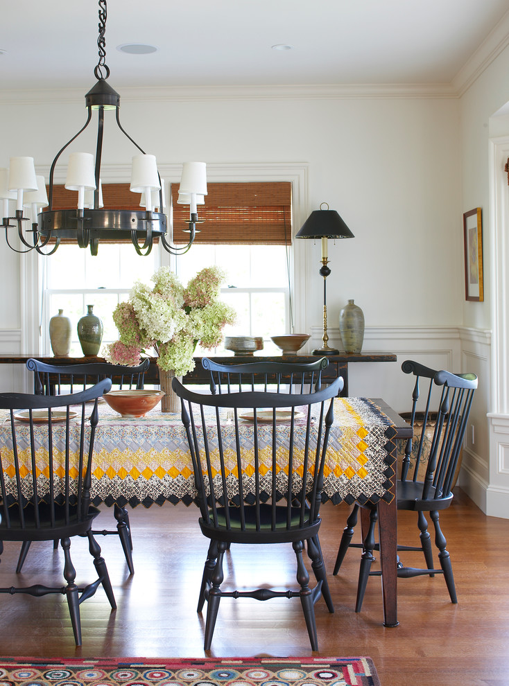 Traditional dining room in Boston with white walls and brown floor.