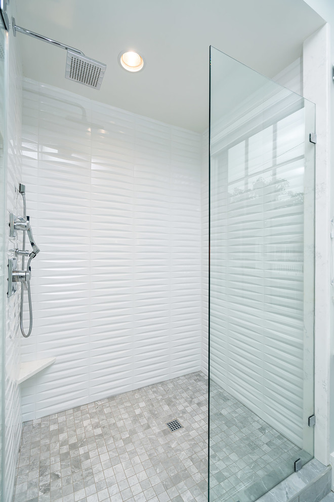 Alcove shower - small transitional master gray tile and ceramic tile ceramic tile and gray floor alcove shower idea with shaker cabinets, blue cabinets, a two-piece toilet, gray walls, an undermount sink, quartz countertops and a hinged shower door