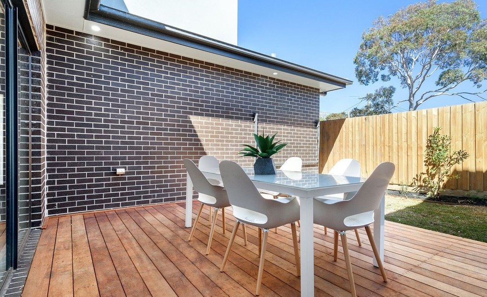 Photo of a mid-sized contemporary backyard deck in Melbourne with with privacy feature and no cover.