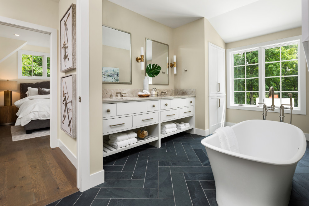 Transitional bathroom in Minneapolis with flat-panel cabinets, white cabinets, a freestanding tub, beige walls, an undermount sink, blue floor, grey benchtops, a double vanity and a built-in vanity.