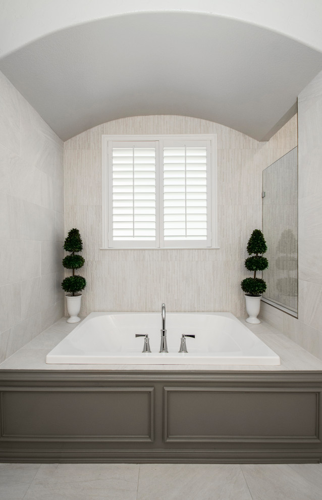 Inspiration for a mid-sized transitional master bathroom in Dallas with raised-panel cabinets, grey cabinets, a drop-in tub, a corner shower, a two-piece toilet, gray tile, porcelain tile, grey walls, porcelain floors, an undermount sink, engineered quartz benchtops, grey floor, a hinged shower door, white benchtops, a double vanity and a built-in vanity.