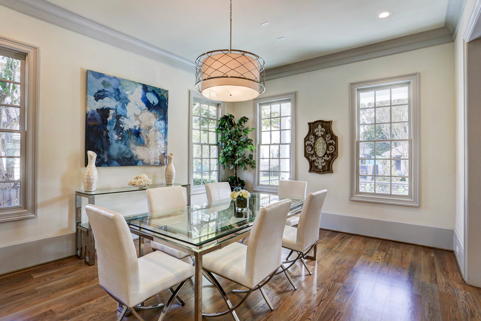 Transitional dining room in Houston with beige walls, medium hardwood floors and no fireplace.