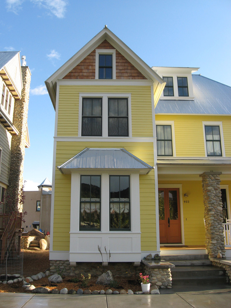 Mid-sized traditional three-storey exterior in Charlotte with wood siding and a metal roof.
