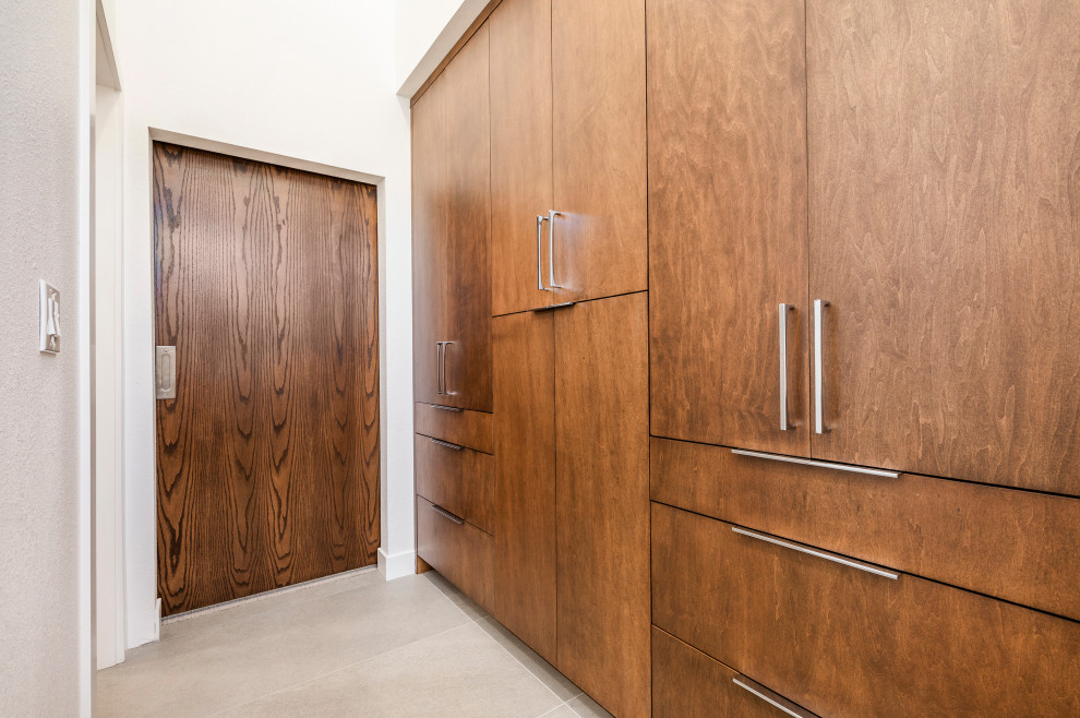 Idée de décoration pour une armoire encastrée nordique de taille moyenne et neutre avec un placard à porte plane, des portes de placard grises, parquet clair et un sol beige.