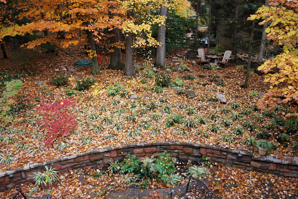 This is an example of a mid-sized country backyard garden in DC Metro with natural stone pavers.