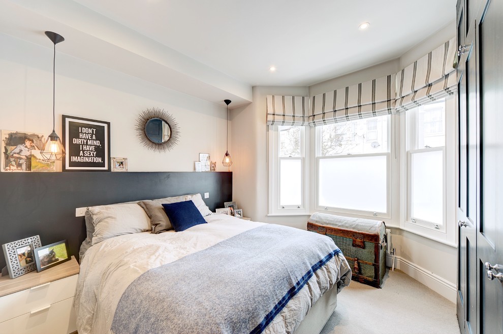 This is an example of a mid-sized contemporary bedroom in London with white walls, carpet and grey floor.